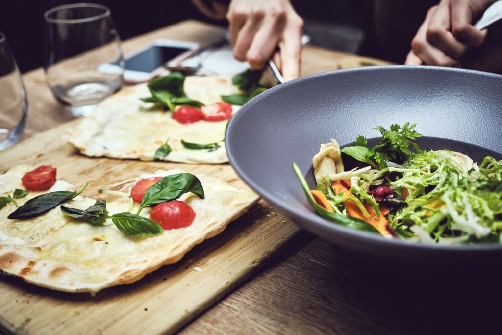 Closeup shot of a person cutting vegetable and making a salad